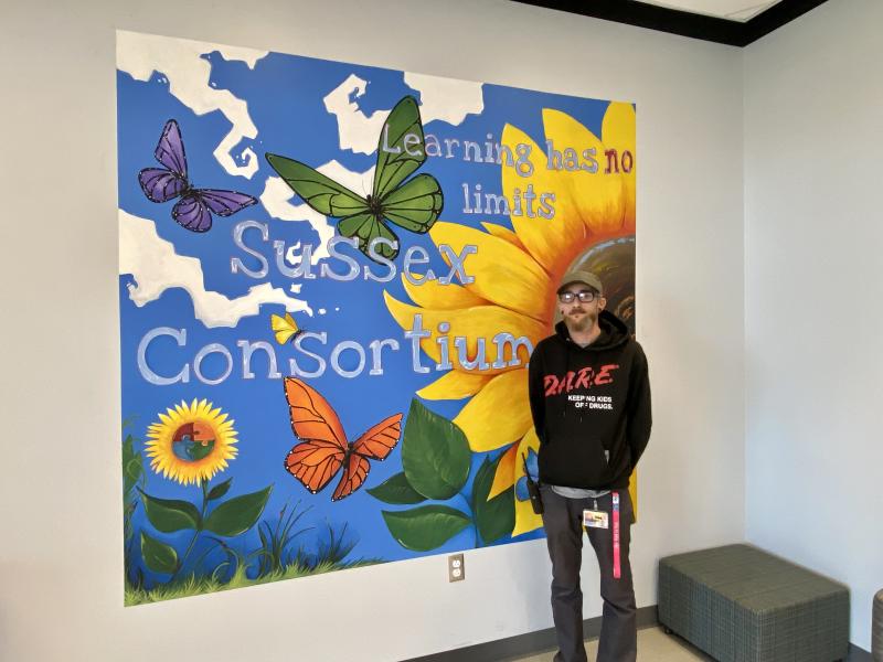 Sussex Consortium head custodian and artist Dan Kimmel painted a cheerful school-themed sunflower field to brighten a hallway for students and staff. ELLEN DRISCOLL PHOTOS